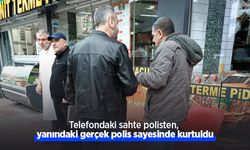 Telefondaki sahte polisten, yanındaki gerçek polis sayesinde kurtuldu