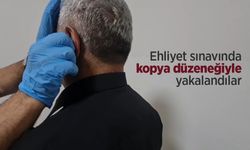 Ehliyet sınavında kopya düzeneğiyle yakalandılar