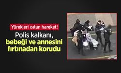 Yürekleri ısıtan hareket! Polis kalkanı, bebeği ve annesini fırtınadan korudu