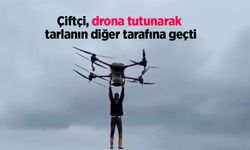 Çiftçi, drona tutunarak tarlanın diğer tarafına geçti