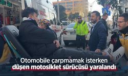 Otomobile çarpmamak isterken düşen motosiklet sürücüsü yaralandı