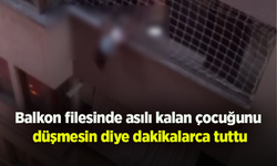 Balkon filesinde asılı kalan çocuğunu düşmesin diye dakikalarca tuttu