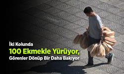Elinde 100 ekmek taşıyan garson görenleri şaşırtıyor