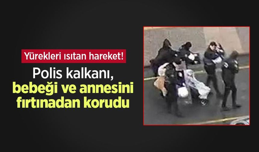 Yürekleri ısıtan hareket! Polis kalkanı, bebeği ve annesini fırtınadan korudu