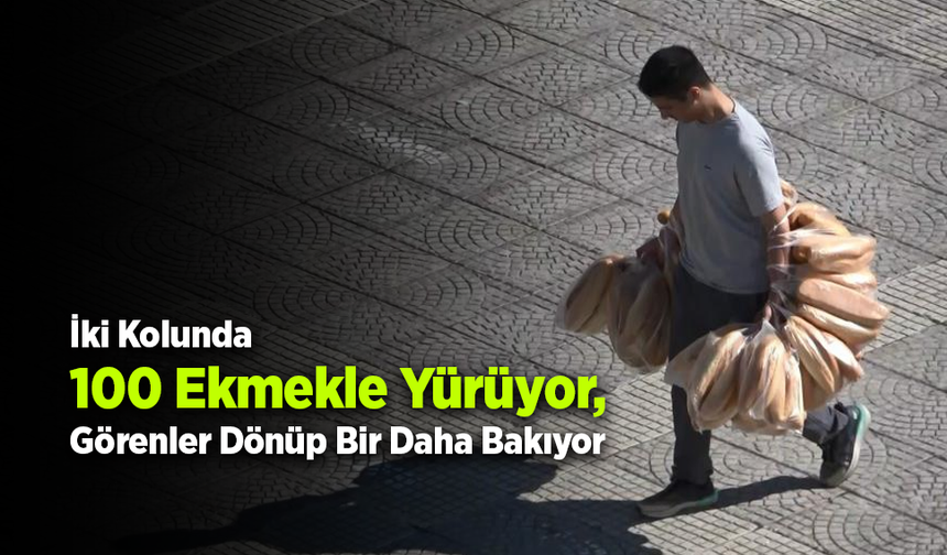 Elinde 100 ekmek taşıyan garson görenleri şaşırtıyor