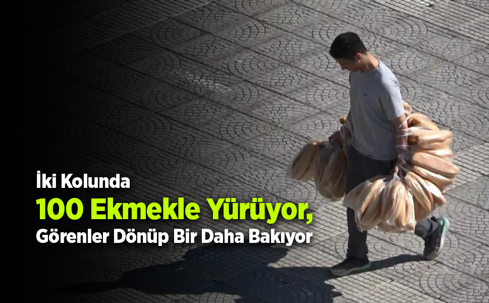 Elinde 100 ekmek taşıyan garson görenleri şaşırtıyor